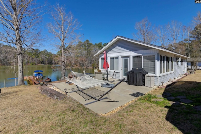 exterior space with a yard, a patio, and a water view