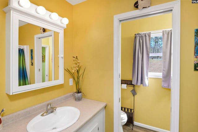 half bathroom with toilet and vanity