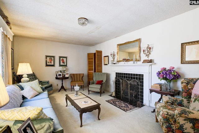 living area with a textured ceiling, a tile fireplace, and carpet flooring