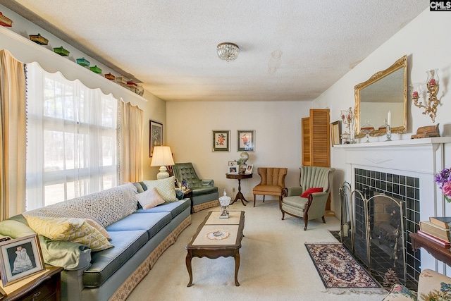 living area with carpet, a textured ceiling, and a tiled fireplace