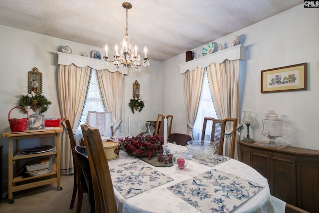 dining space featuring a textured ceiling, light carpet, and a notable chandelier