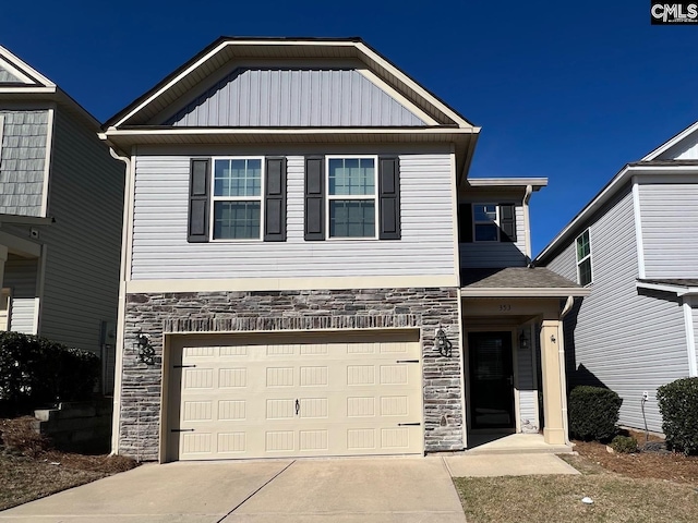 view of front facade with a garage, stone siding, board and batten siding, and concrete driveway