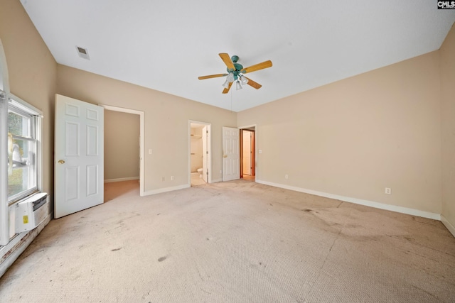 unfurnished bedroom featuring light colored carpet, visible vents, and baseboards