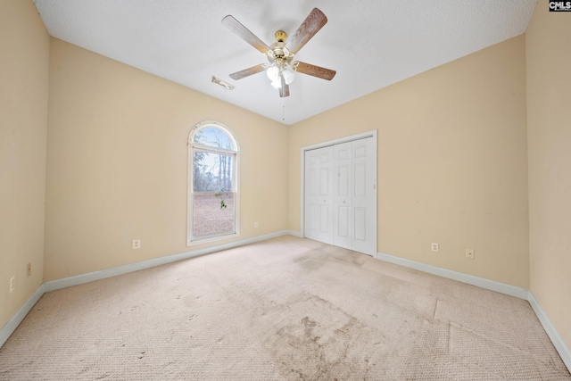 unfurnished bedroom featuring visible vents, a closet, baseboards, and carpet flooring