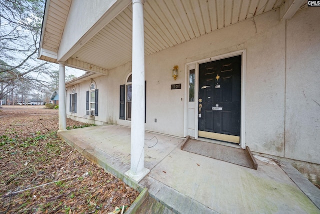 property entrance featuring a patio area and stucco siding