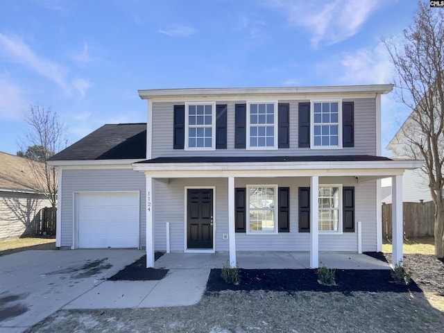 traditional-style home featuring a garage, concrete driveway, a porch, and fence