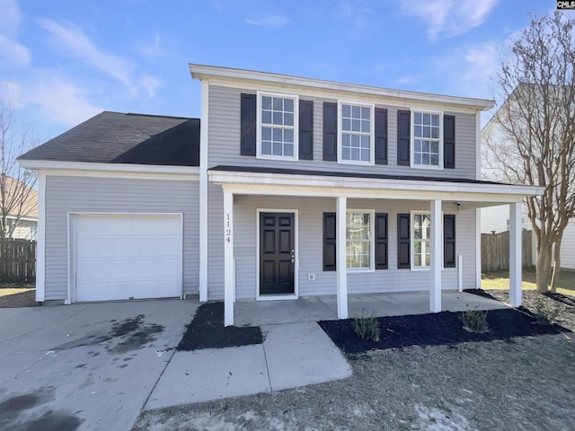 traditional-style home featuring a porch, an attached garage, and fence