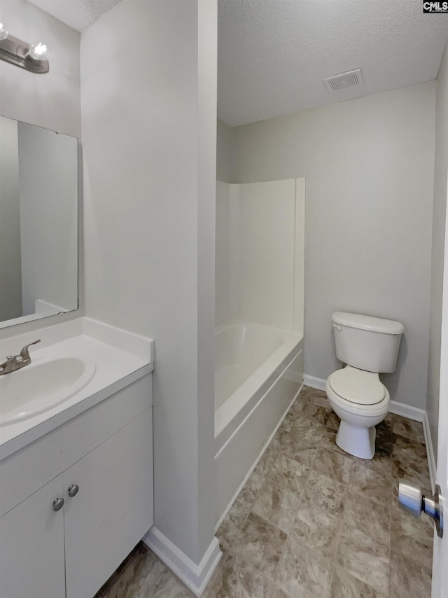 bathroom featuring visible vents, toilet, a textured ceiling, vanity, and baseboards