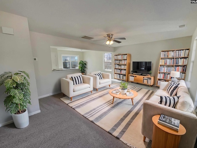 living area featuring ceiling fan, carpet, visible vents, and baseboards