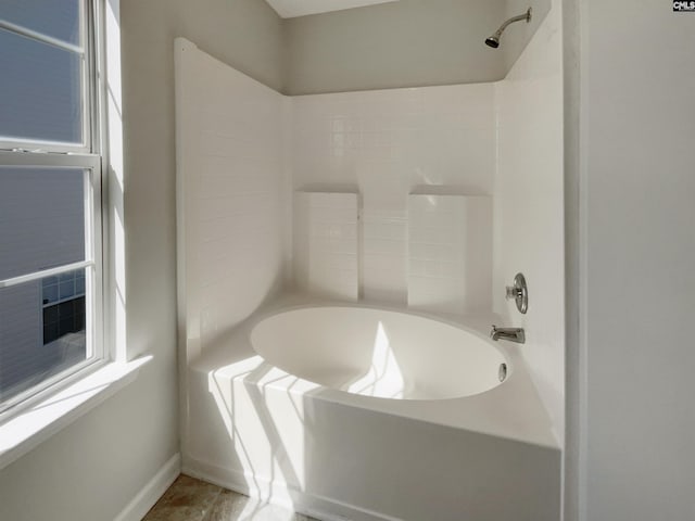 full bathroom with baseboards and bathing tub / shower combination