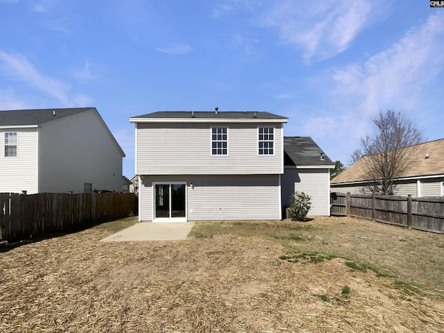 back of property with a patio area and a fenced backyard