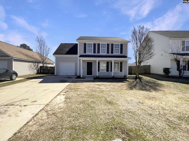 traditional-style home featuring a garage, concrete driveway, and fence