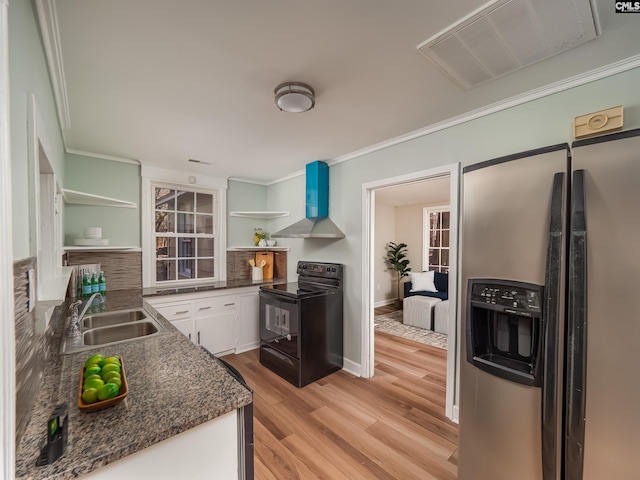 kitchen featuring black range with electric cooktop, open shelves, a sink, stainless steel refrigerator with ice dispenser, and wall chimney exhaust hood