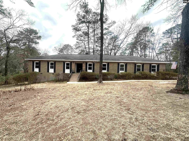 ranch-style home featuring brick siding