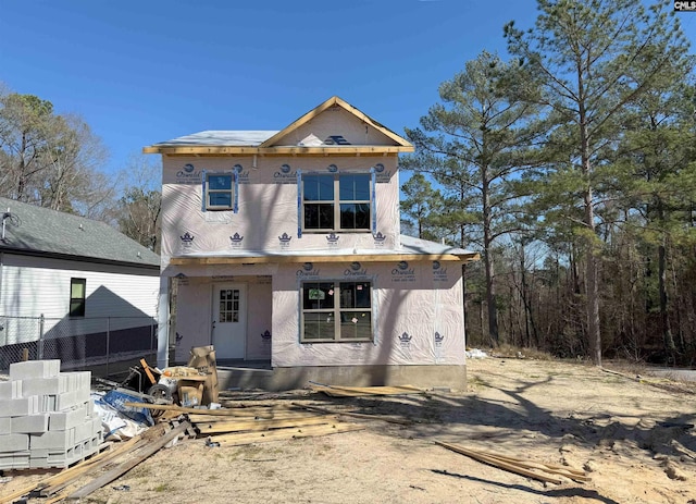 property in mid-construction featuring fence and stucco siding