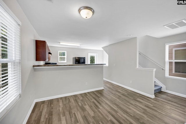 interior space with wood finished floors, visible vents, and baseboards