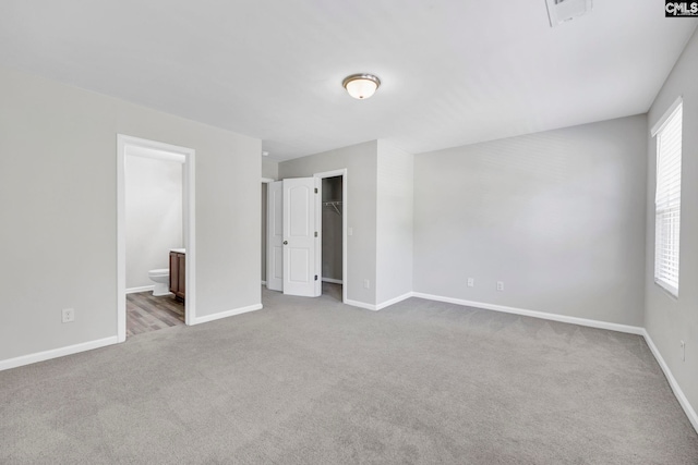 unfurnished bedroom with carpet, visible vents, and baseboards