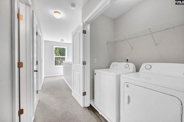 laundry room featuring laundry area, carpet, baseboards, and independent washer and dryer