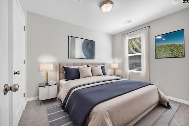 bedroom with carpet flooring, visible vents, and baseboards