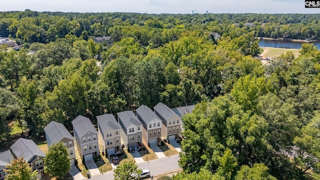 aerial view with a water view, a wooded view, and a residential view