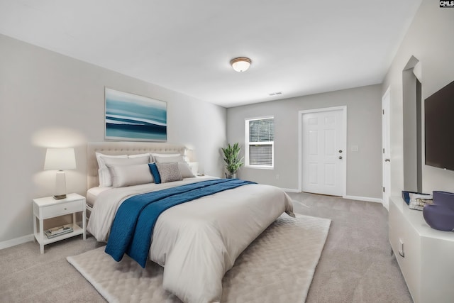 carpeted bedroom featuring visible vents and baseboards