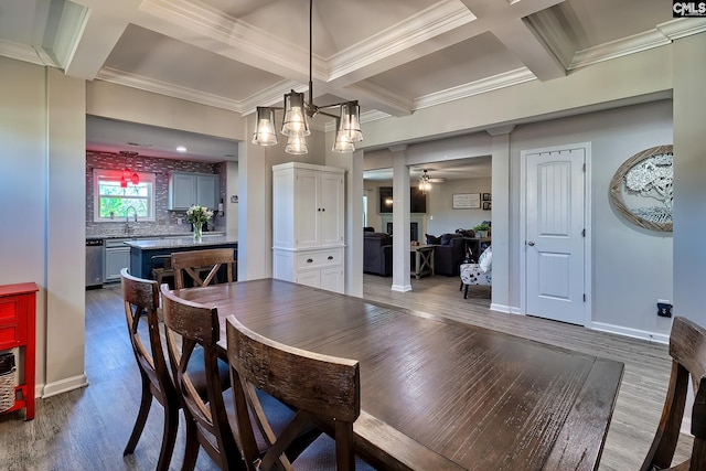 dining area featuring baseboards, coffered ceiling, wood finished floors, crown molding, and beam ceiling