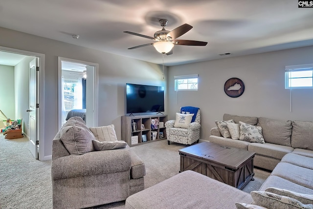 carpeted living area with visible vents, ceiling fan, and baseboards