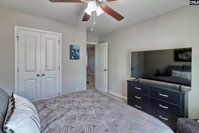 bedroom featuring ceiling fan, baseboards, a closet, and light colored carpet