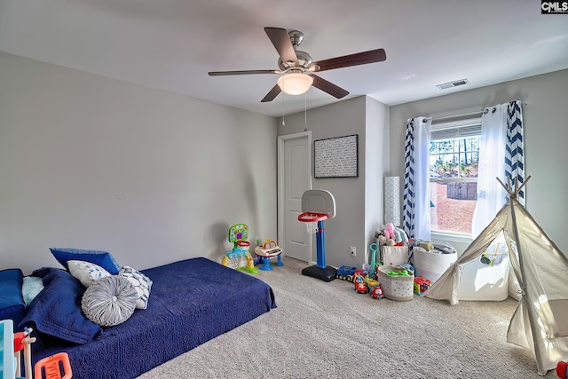 carpeted bedroom with visible vents and a ceiling fan