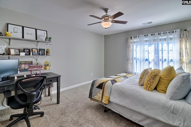 carpeted bedroom with a ceiling fan, visible vents, and baseboards