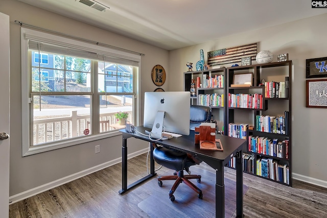 home office featuring baseboards, visible vents, and wood finished floors