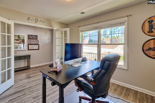 office featuring french doors, visible vents, and wood finished floors