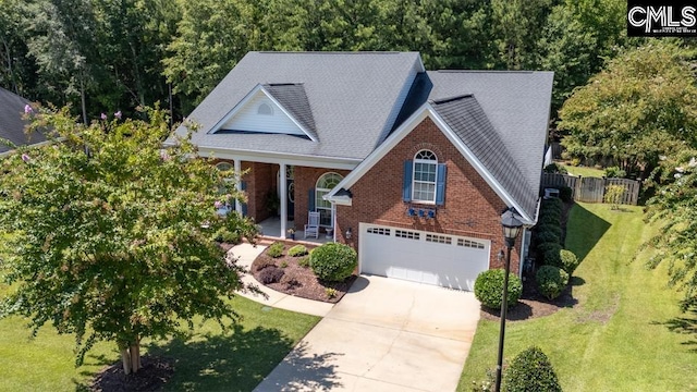 view of front facade featuring driveway, brick siding, an attached garage, a porch, and a front yard