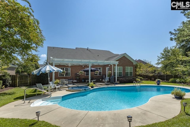 view of swimming pool with a patio, an in ground hot tub, fence, a yard, and a fenced in pool