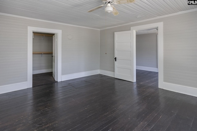 unfurnished bedroom with dark wood-style floors, crown molding, a closet, ceiling fan, and baseboards