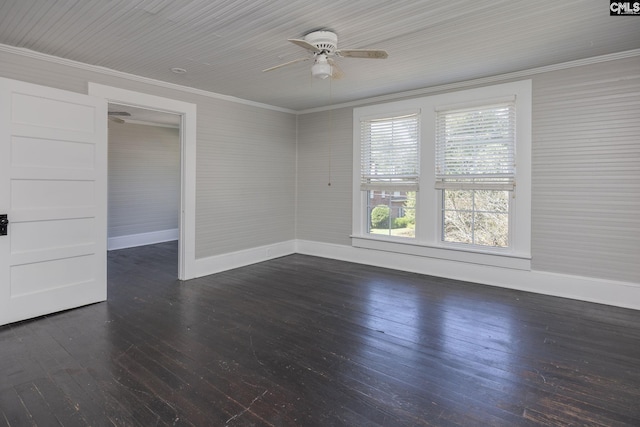 spare room with dark wood-style flooring, crown molding, baseboards, and ceiling fan