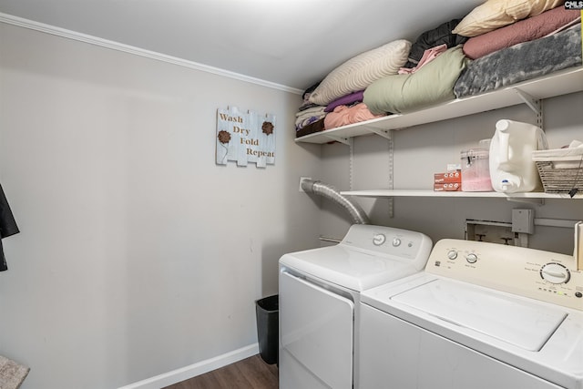 clothes washing area featuring wood finished floors, laundry area, baseboards, and separate washer and dryer