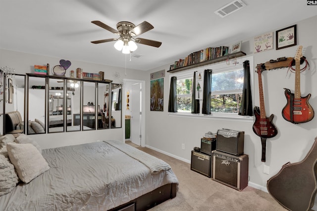 carpeted bedroom with visible vents, ceiling fan, and baseboards