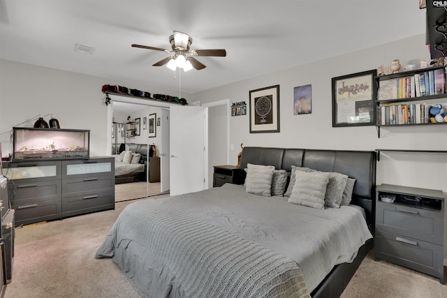 bedroom with ceiling fan, visible vents, and light colored carpet