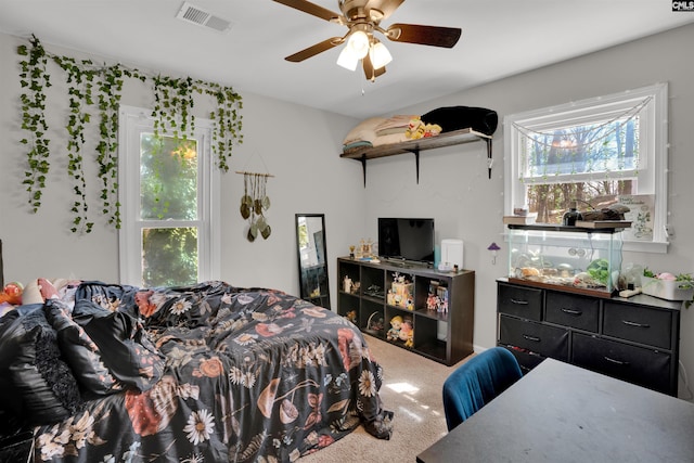 carpeted bedroom featuring visible vents and ceiling fan