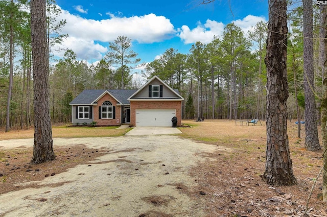 view of front facade with driveway, an attached garage, a front yard, and brick siding