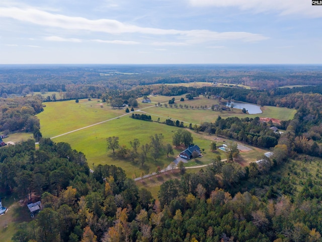 aerial view featuring a rural view and a wooded view