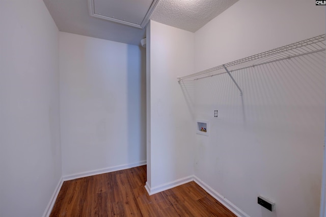 clothes washing area with laundry area, baseboards, washer hookup, and dark wood finished floors