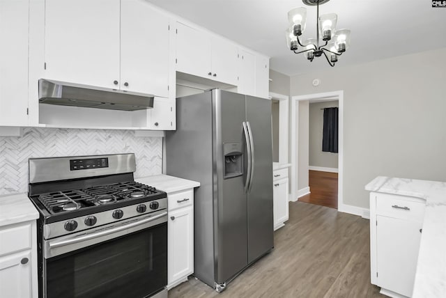 kitchen featuring stainless steel appliances, tasteful backsplash, white cabinetry, and under cabinet range hood