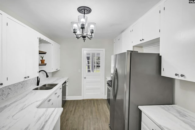 kitchen with stainless steel appliances, a sink, white cabinetry, dark wood-style floors, and open shelves