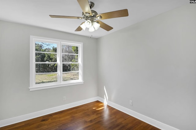 unfurnished room featuring ceiling fan, dark wood finished floors, and baseboards