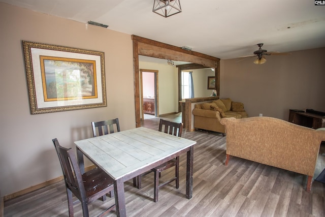 dining room with visible vents, ceiling fan, and wood finished floors