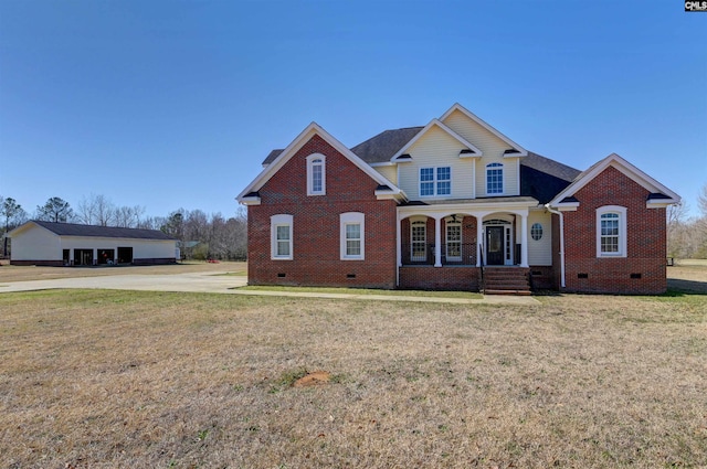 traditional-style house with a front yard, crawl space, brick siding, and covered porch