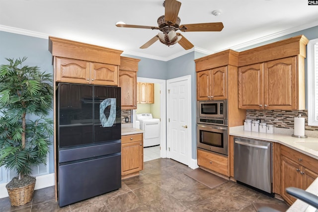 kitchen with backsplash, stainless steel appliances, crown molding, and independent washer and dryer