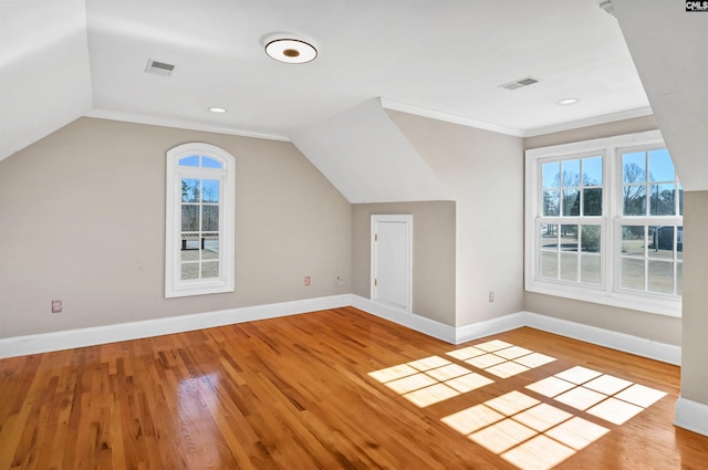 bonus room featuring baseboards, visible vents, and wood finished floors